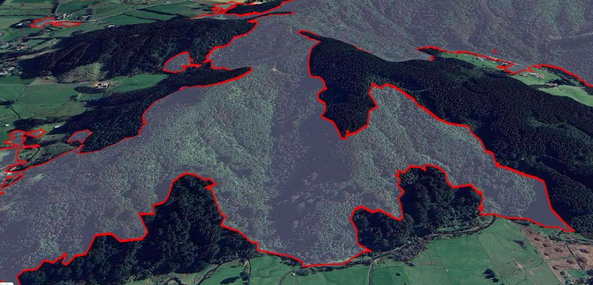 Aerial view of forested hills with red outlines marking mature native forest detected by the Eco-index Observer AI model